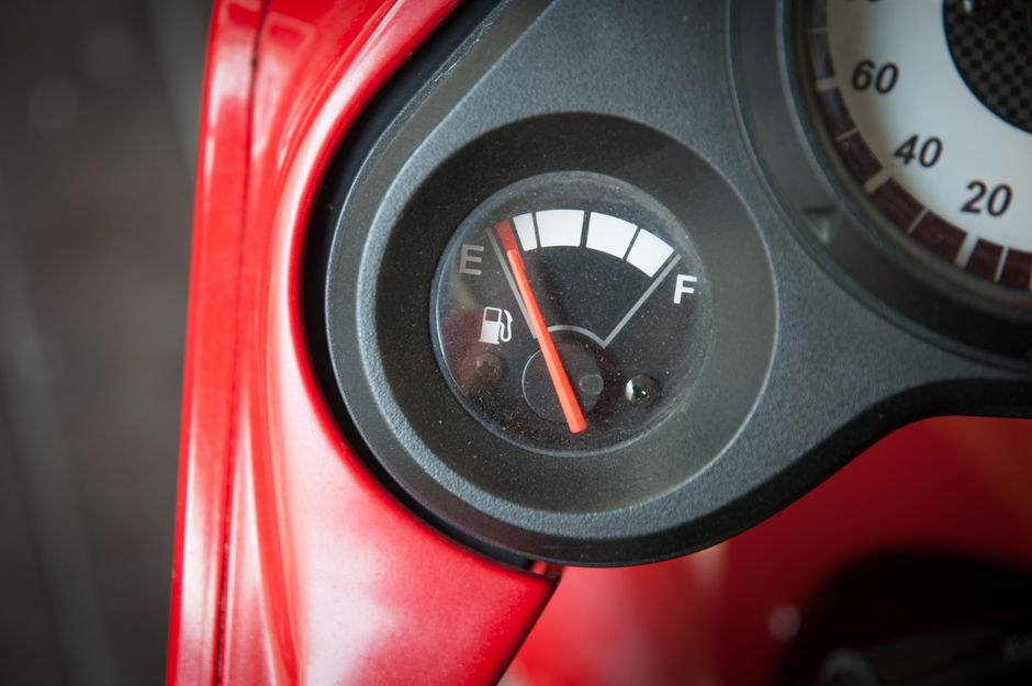 Close-up image of a car fuel gauge with the needle pointing to empty.